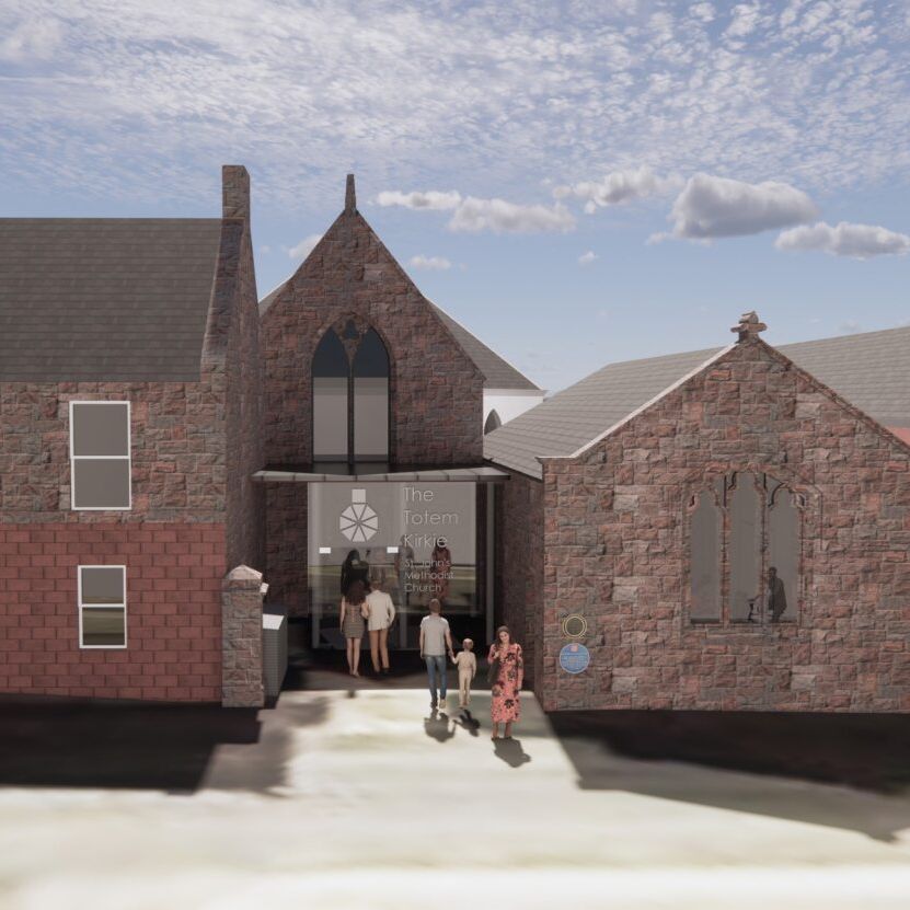 People entering a brick church building with a modern glass entryway.