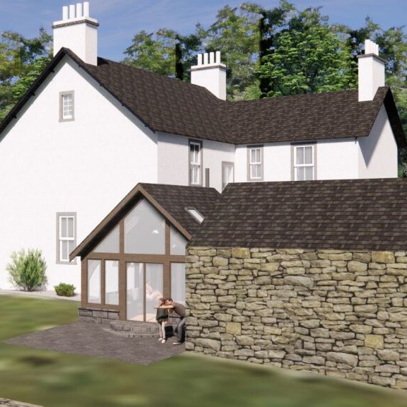 White country house with a modern glass extension and stone wall in a green garden