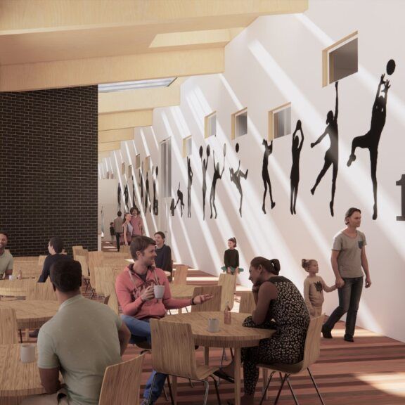 Café interior with people sitting at tables and wall art of sports silhouettes