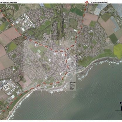 Aerial map of a coastal town with major routes marked and highlighted boundary lines.