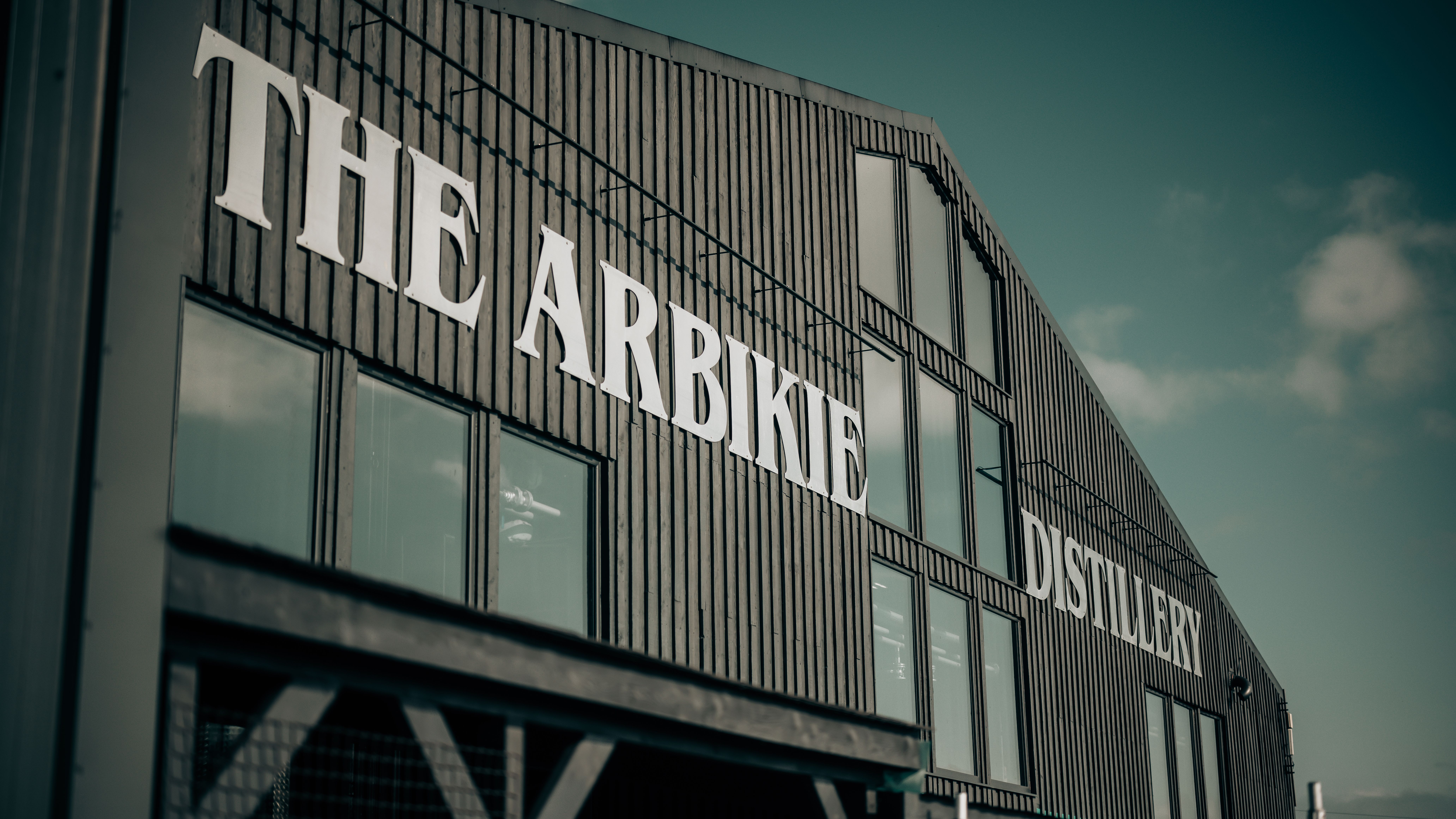 Exterior of The Arbikie Distillery building with large white signage