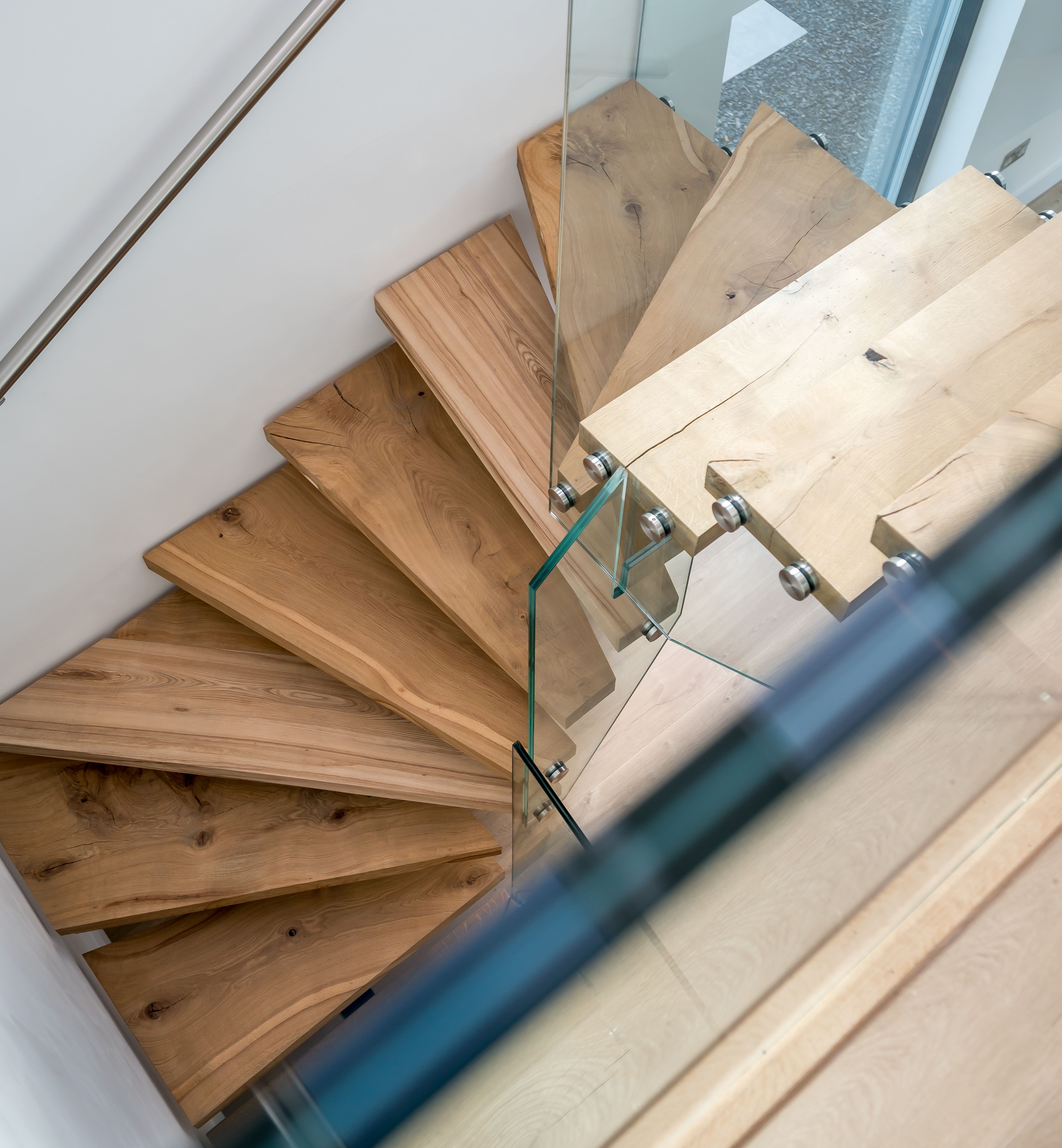 Modern wooden staircase with glass railing