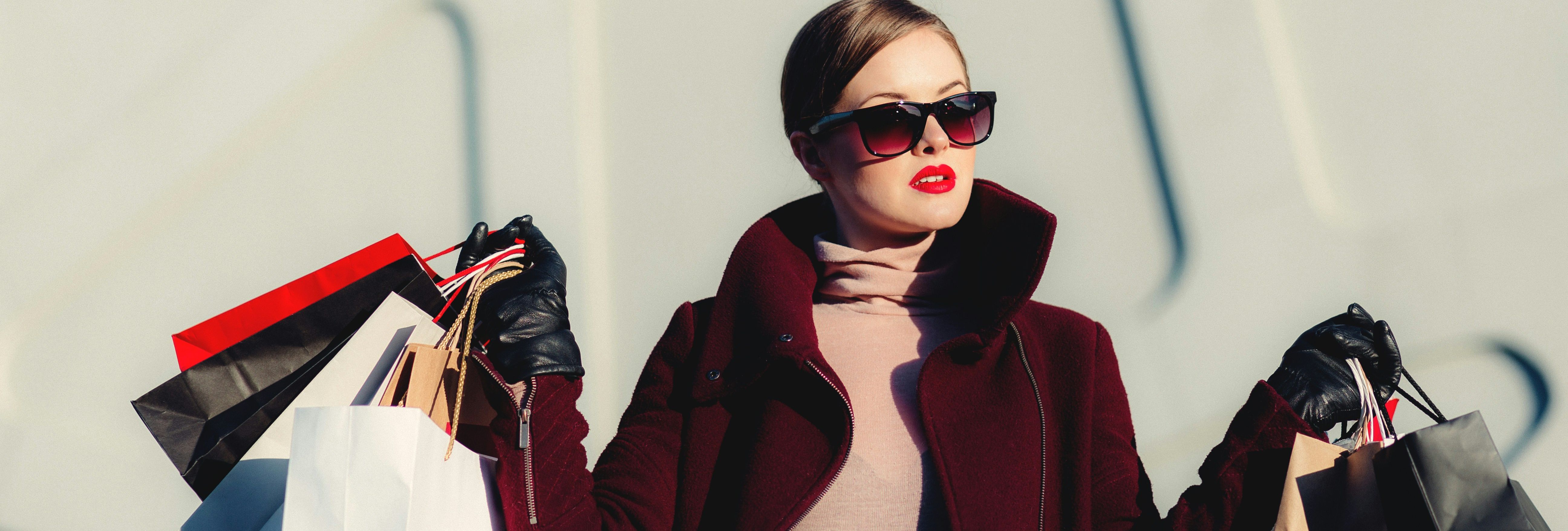 Fashionable woman holding multiple shopping bags
