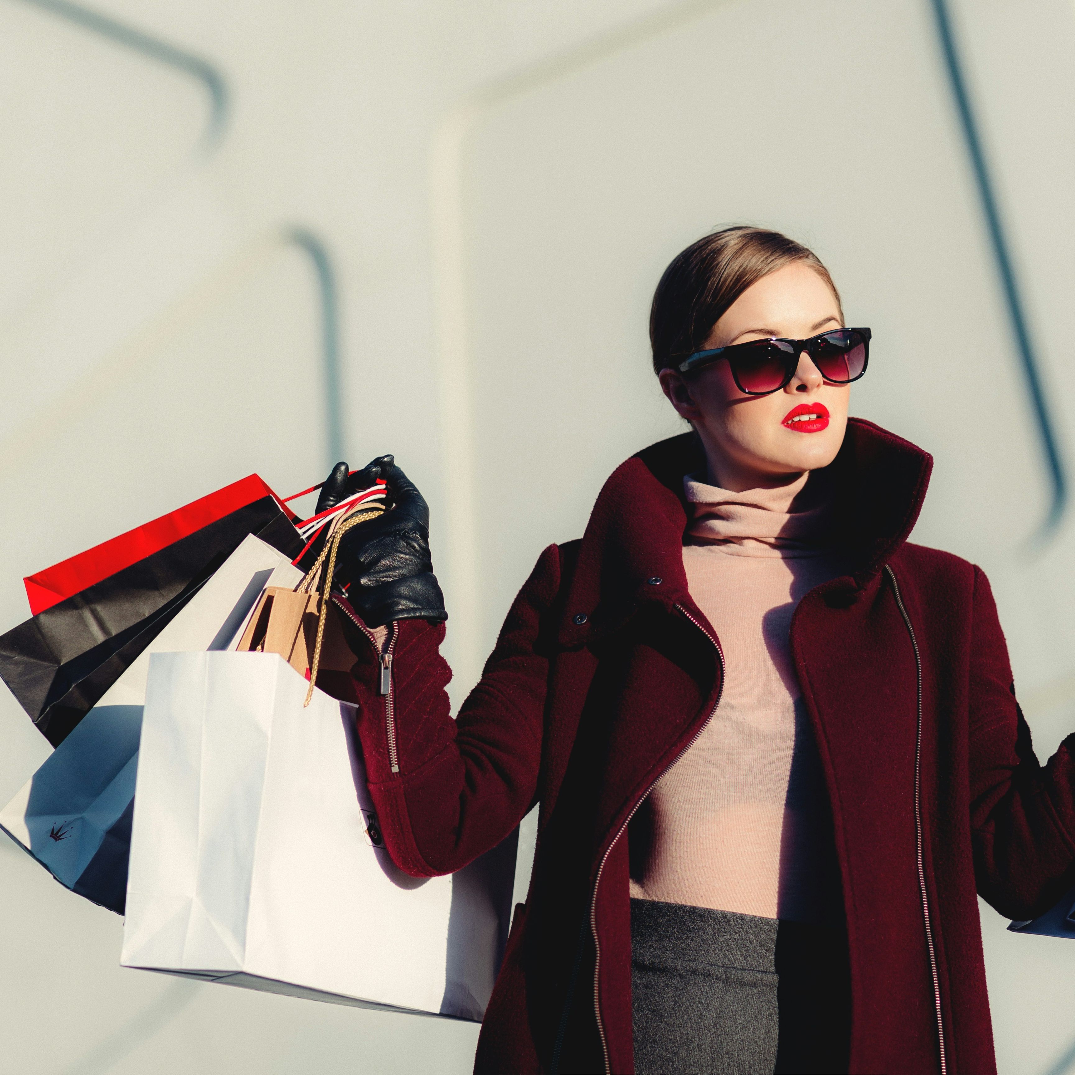 Fashionable woman holding multiple shopping bags