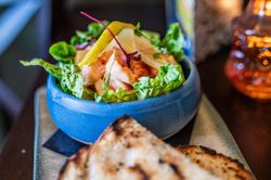prawn salad in a dish with a side of bread
