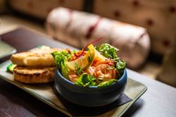 prawn salad in a dish with a side of bread