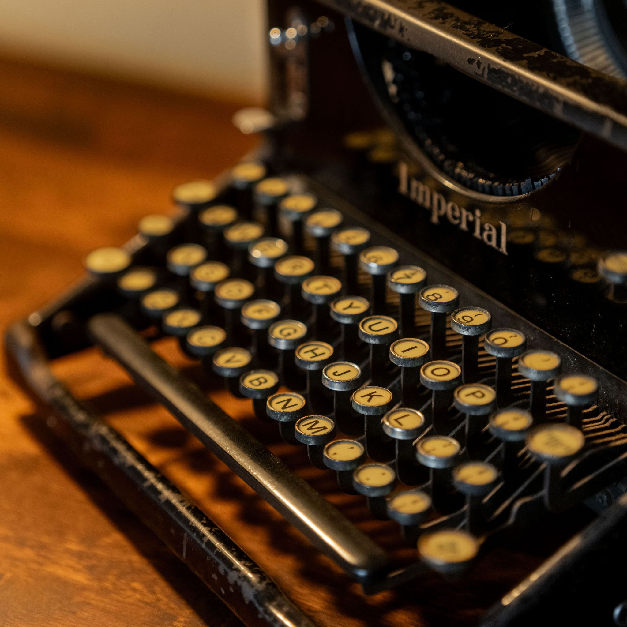 Close-up of an antique Imperial typewriter on a wooden desk