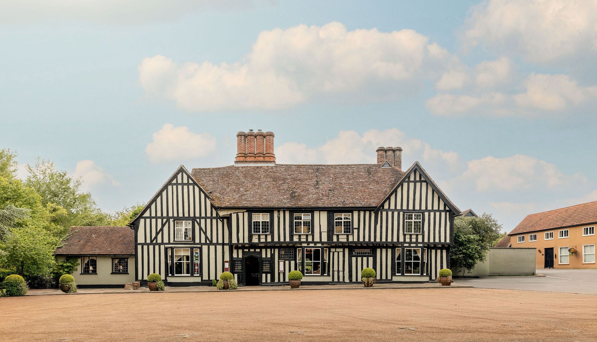 Traditional Tudor-style building with black timber framing and white infill panels