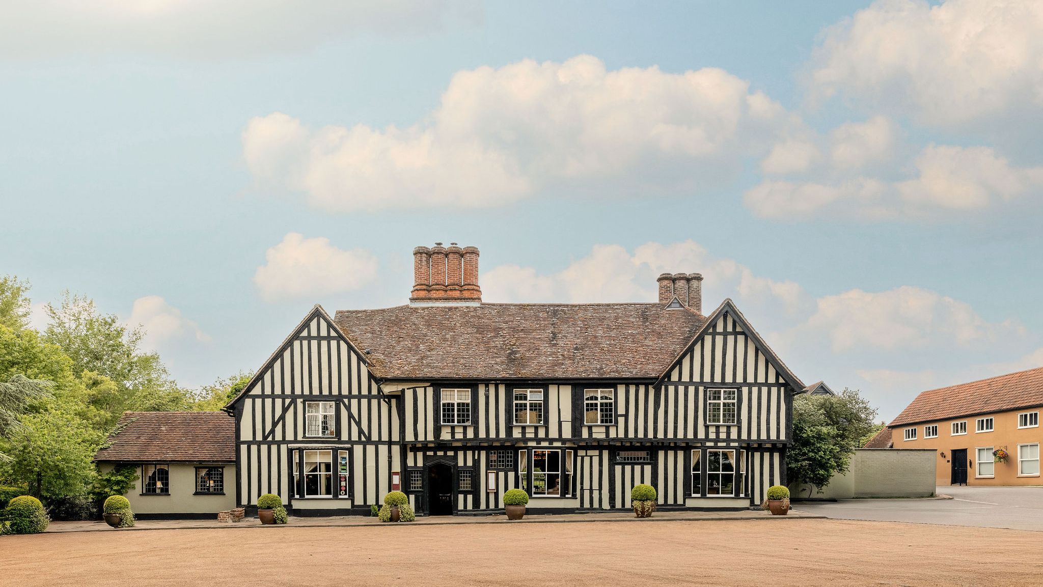 Traditional Tudor-style building with black timber framing and white infill panels