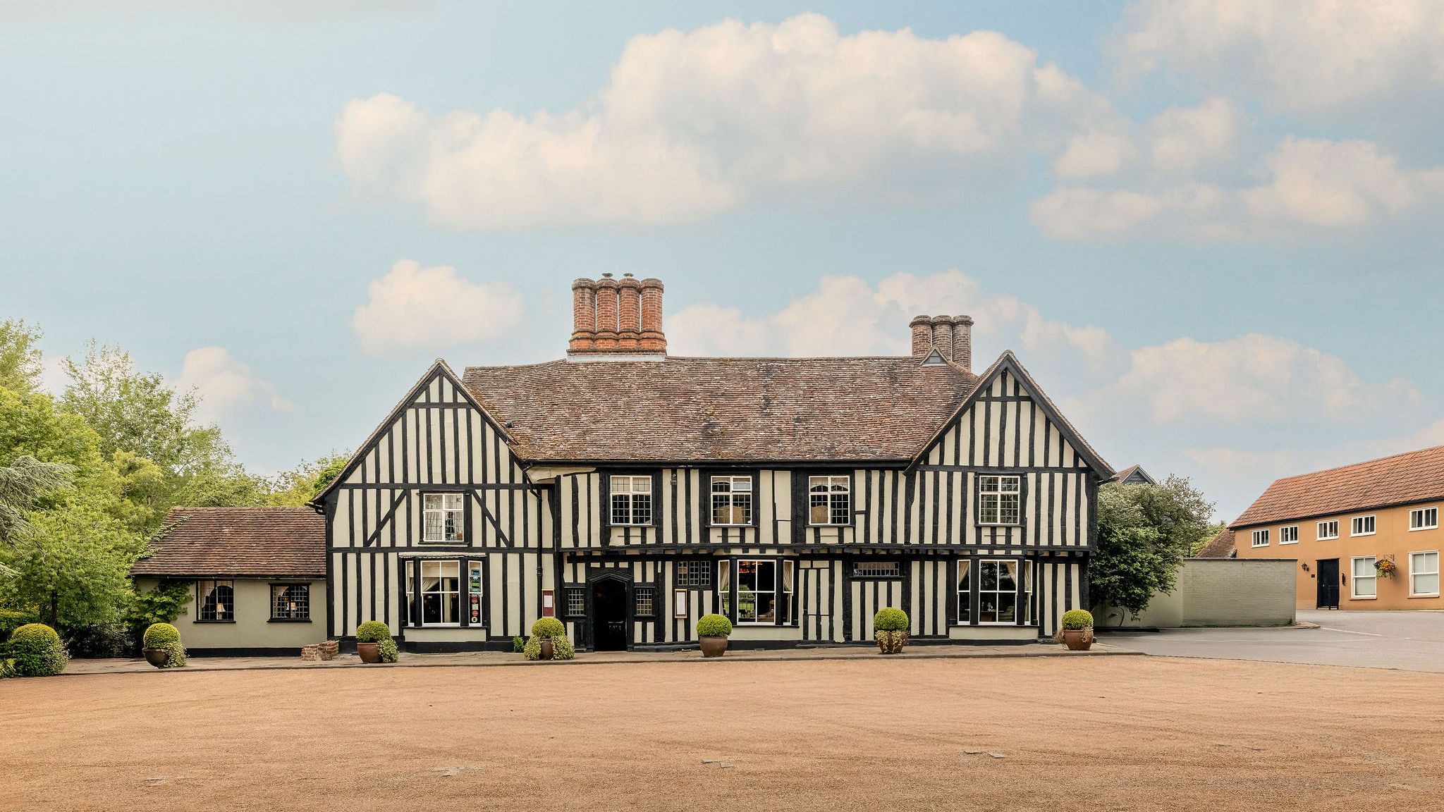 Traditional Tudor-style building with black timber framing and white infill panels