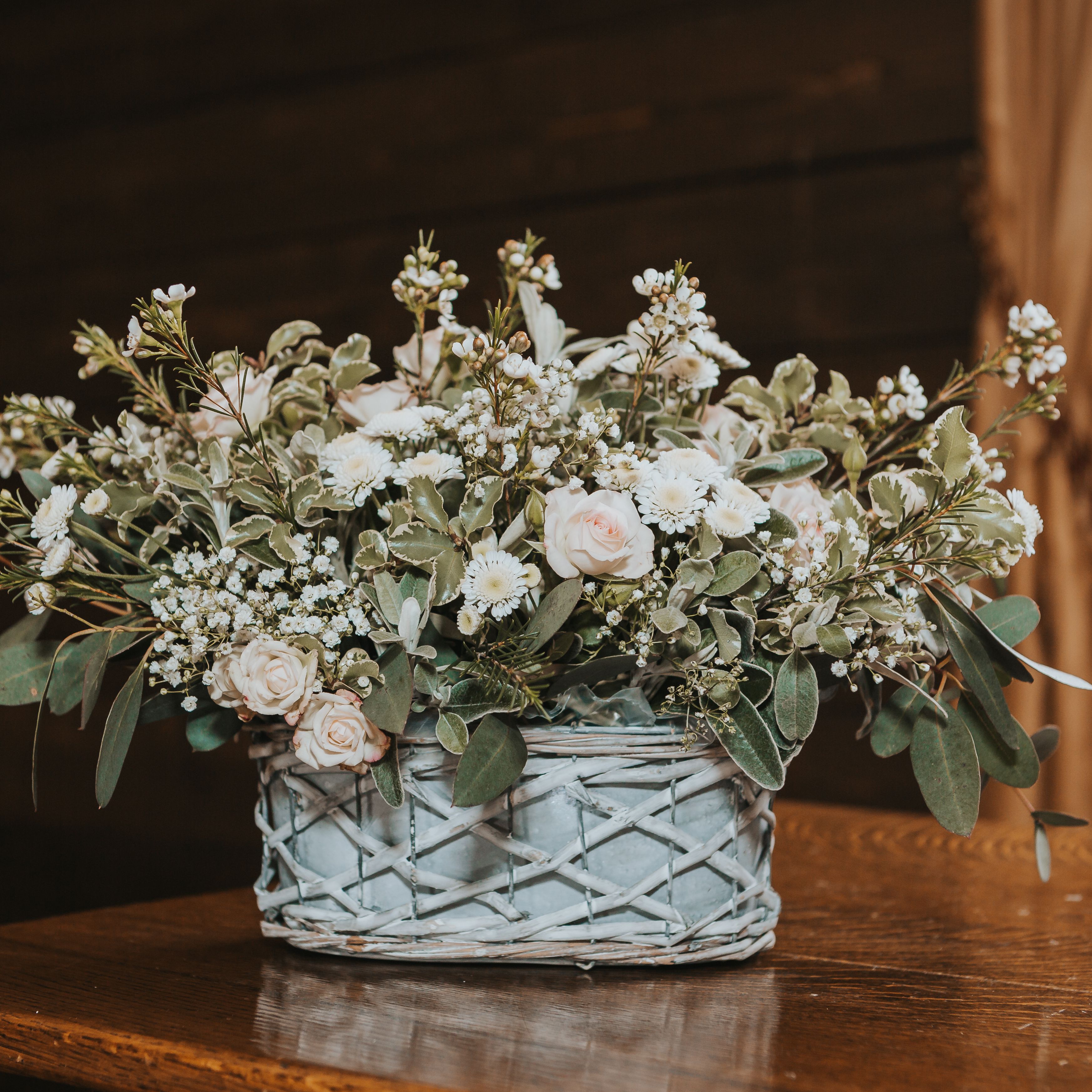 Wedding flowers on a table with roses and eucalyptus