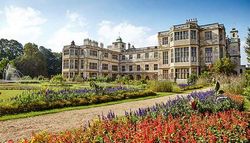 Historic mansion with formal gardens and colorful flowers in front