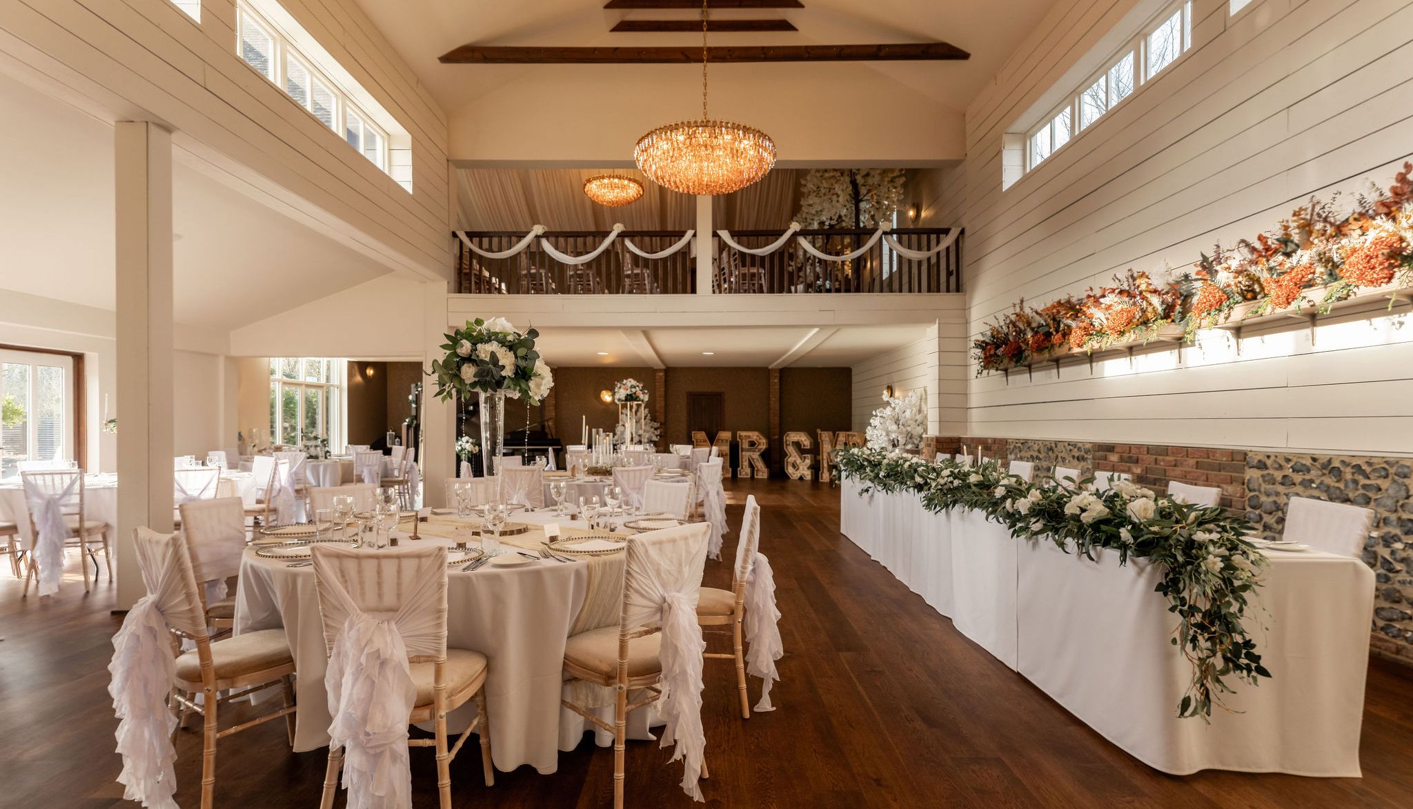 Elegant wedding reception hall with decorated tables and floral arrangements