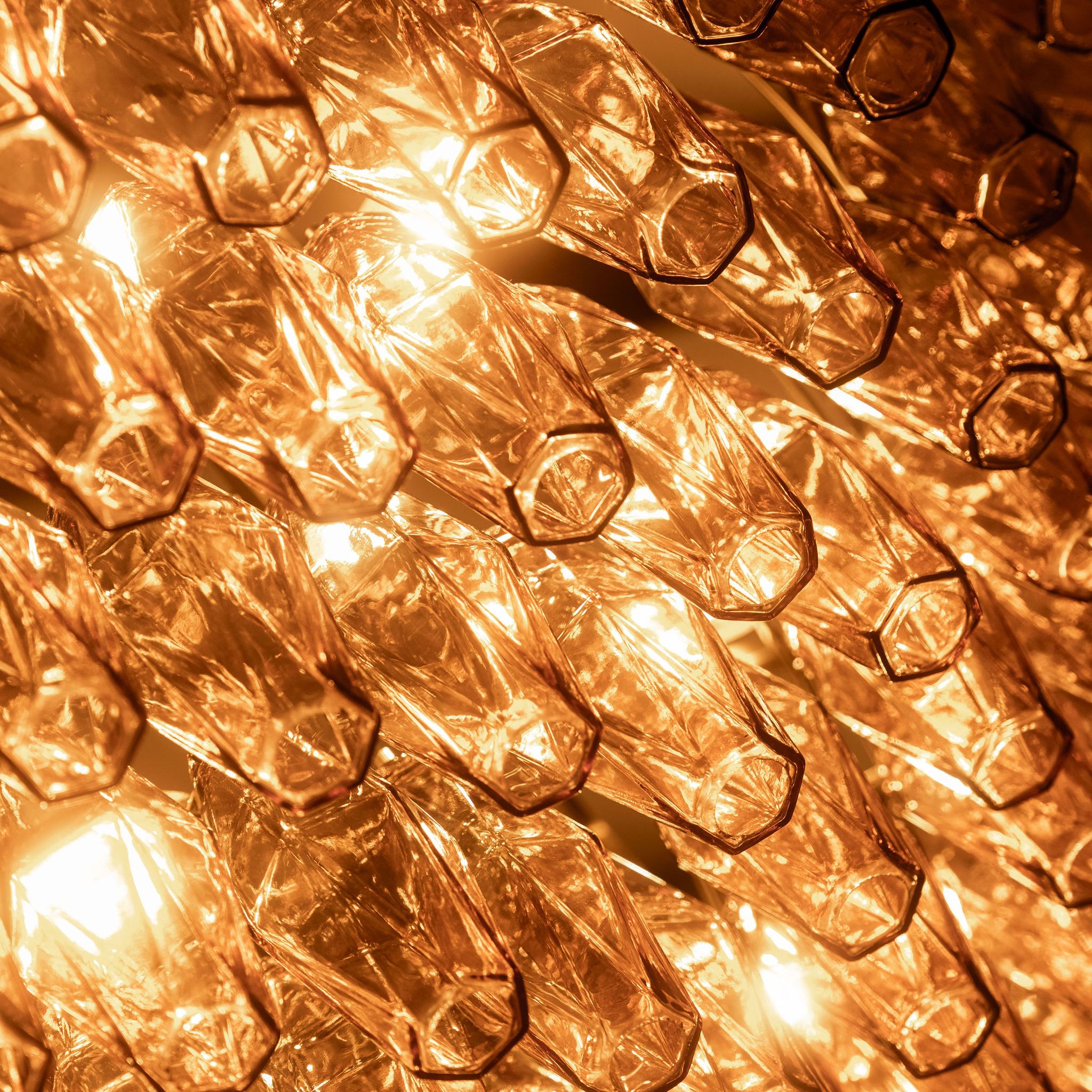 Close-up of illuminated glass chandelier prisms
