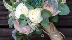 Green, white & baby pink flower bouquet wrapped in brown paper and tied with a string