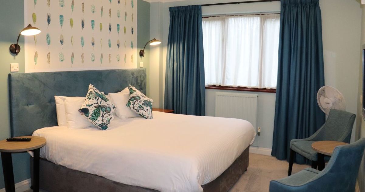 Double room with wallpaper above the bed