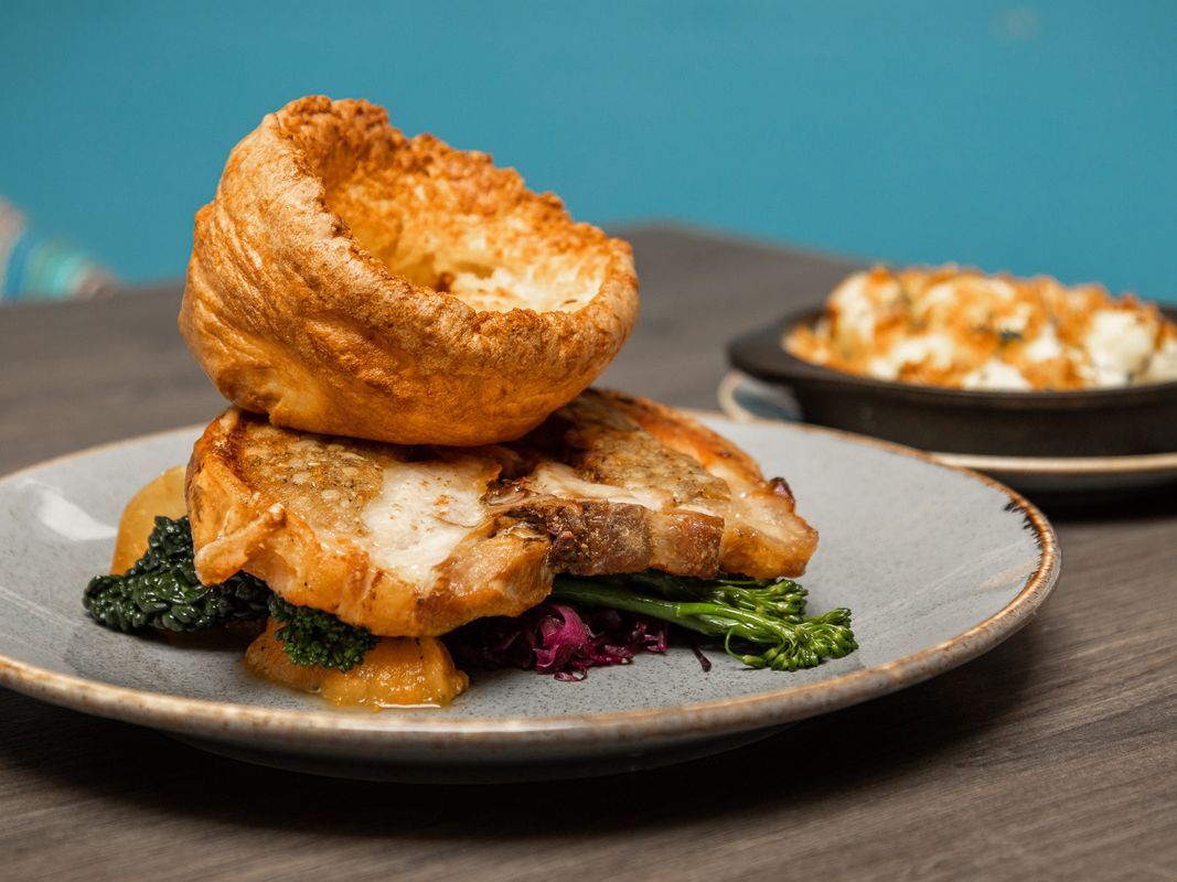 Side view of Chicken & stuffing roast with yorkshire pudding & vegetables