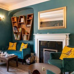 Lounge at wisteria hotel with a book case in the shape of a W