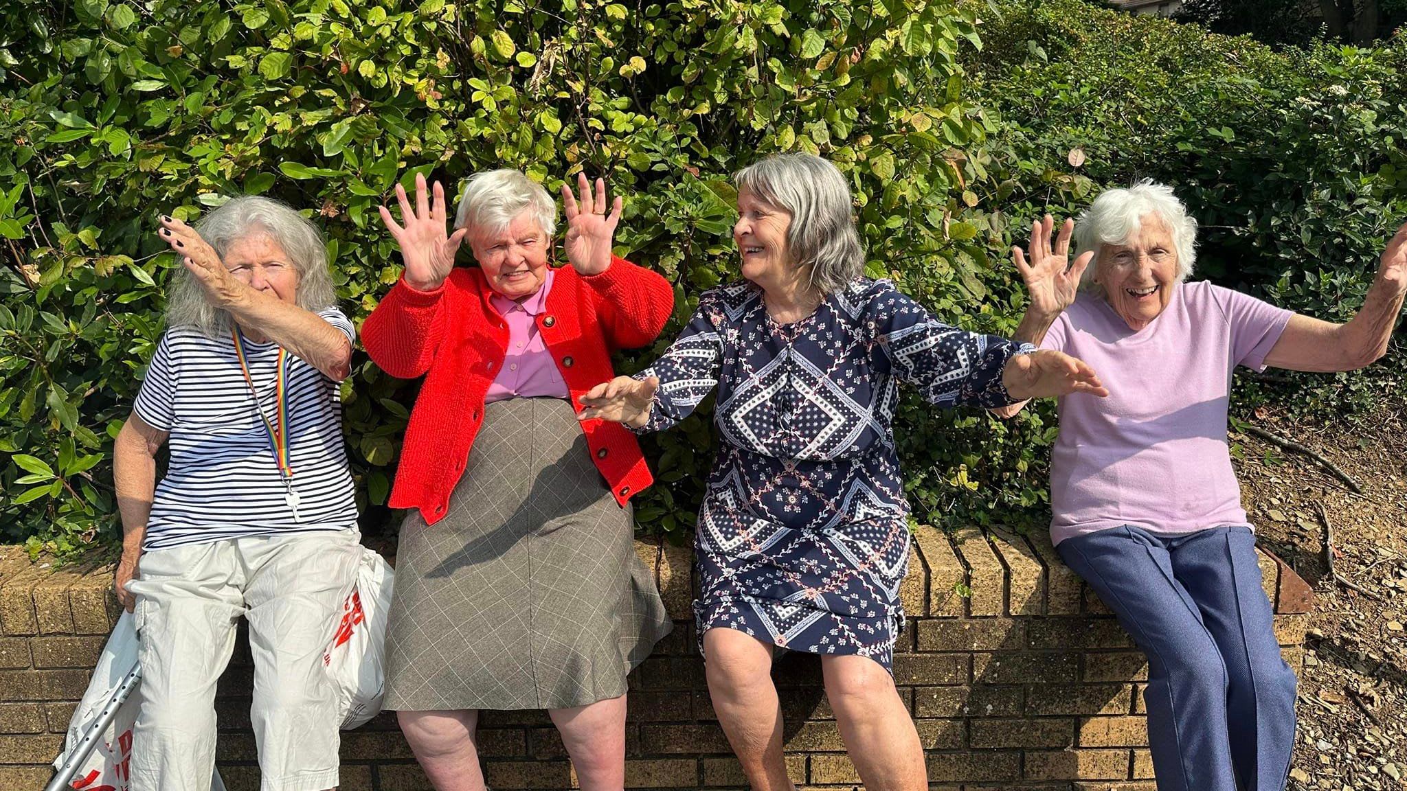 Ladies sitting on a wall