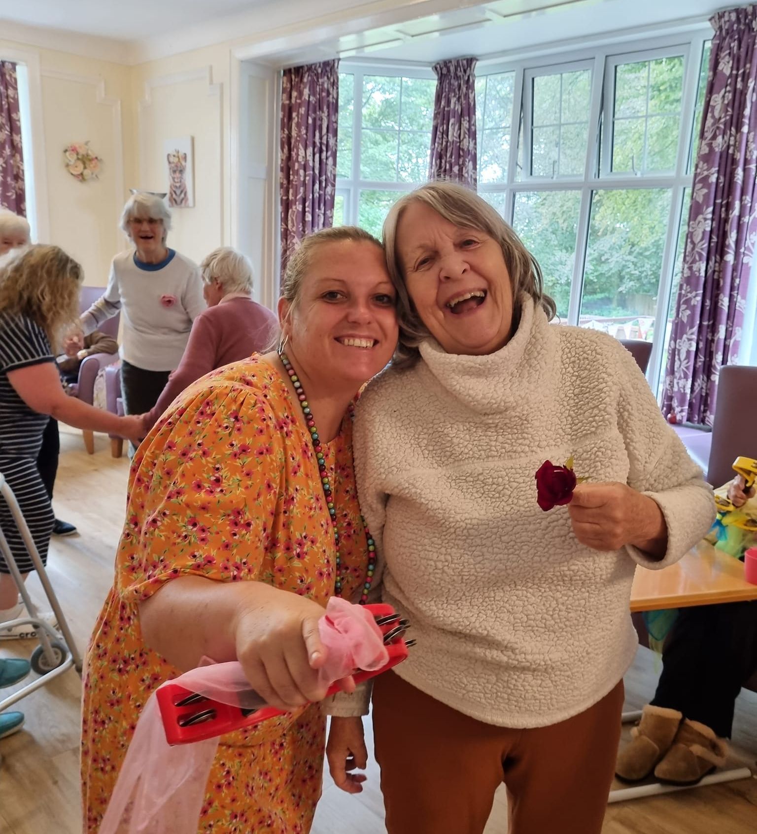 Resident dancing with staff member