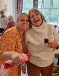 Resident dancing with staff member