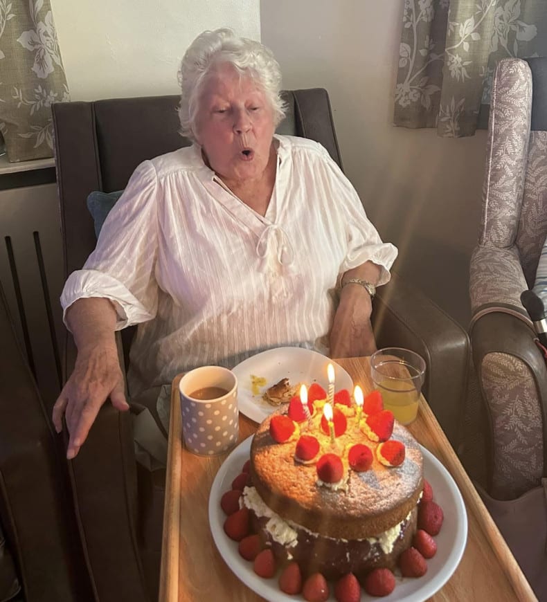 Woman blowing out cake