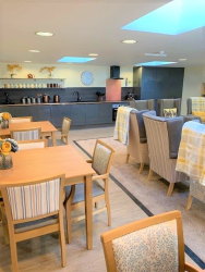 Care home lounge with tables and chairs