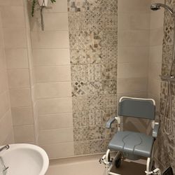 accessible wet room with sandy tiles
