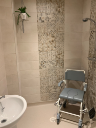 accessible wet room with sandy tiles