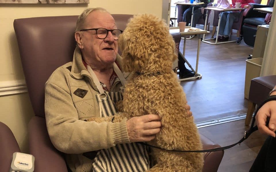 Man with Dog on his lap