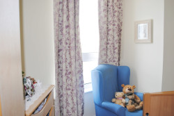 Bedroom with teddy beards in an armchair
