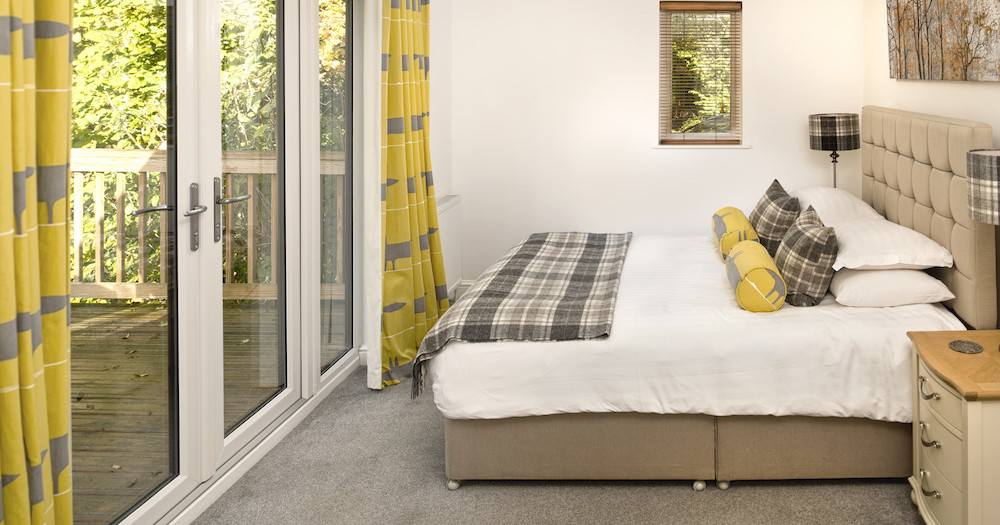 Kingfisher Lodge Main Bedroom with large bed and access to ptivate balcony