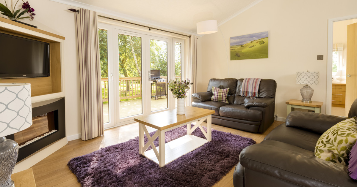 Rabbitdale Lodge living area with dining table and large comfy sofas