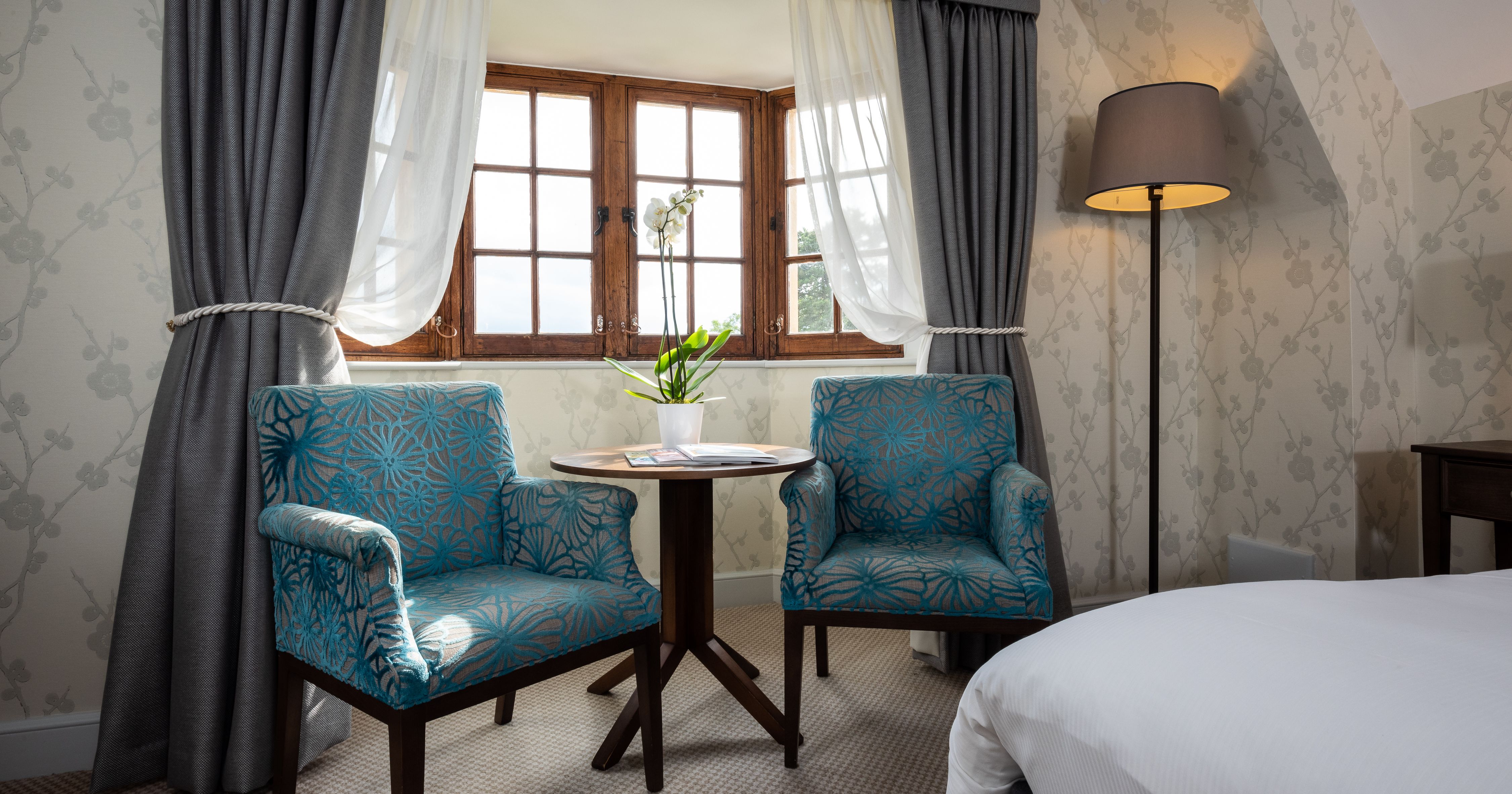 Bedroom with arm chairs and a coffee table
