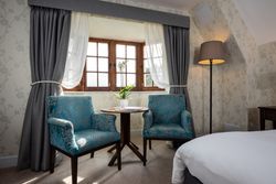 Bedroom with arm chairs and a coffee table