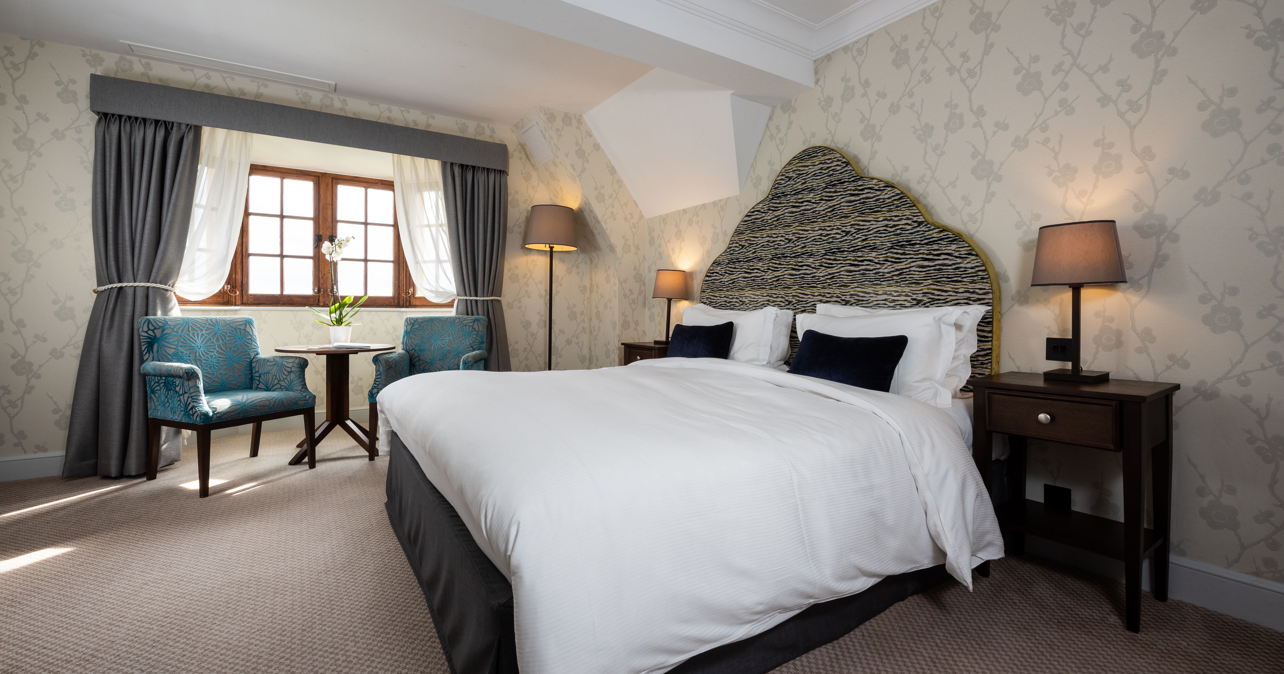 Bedroom with arm chairs and a coffee table