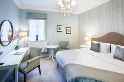 Bedroom with dressing table and large bed