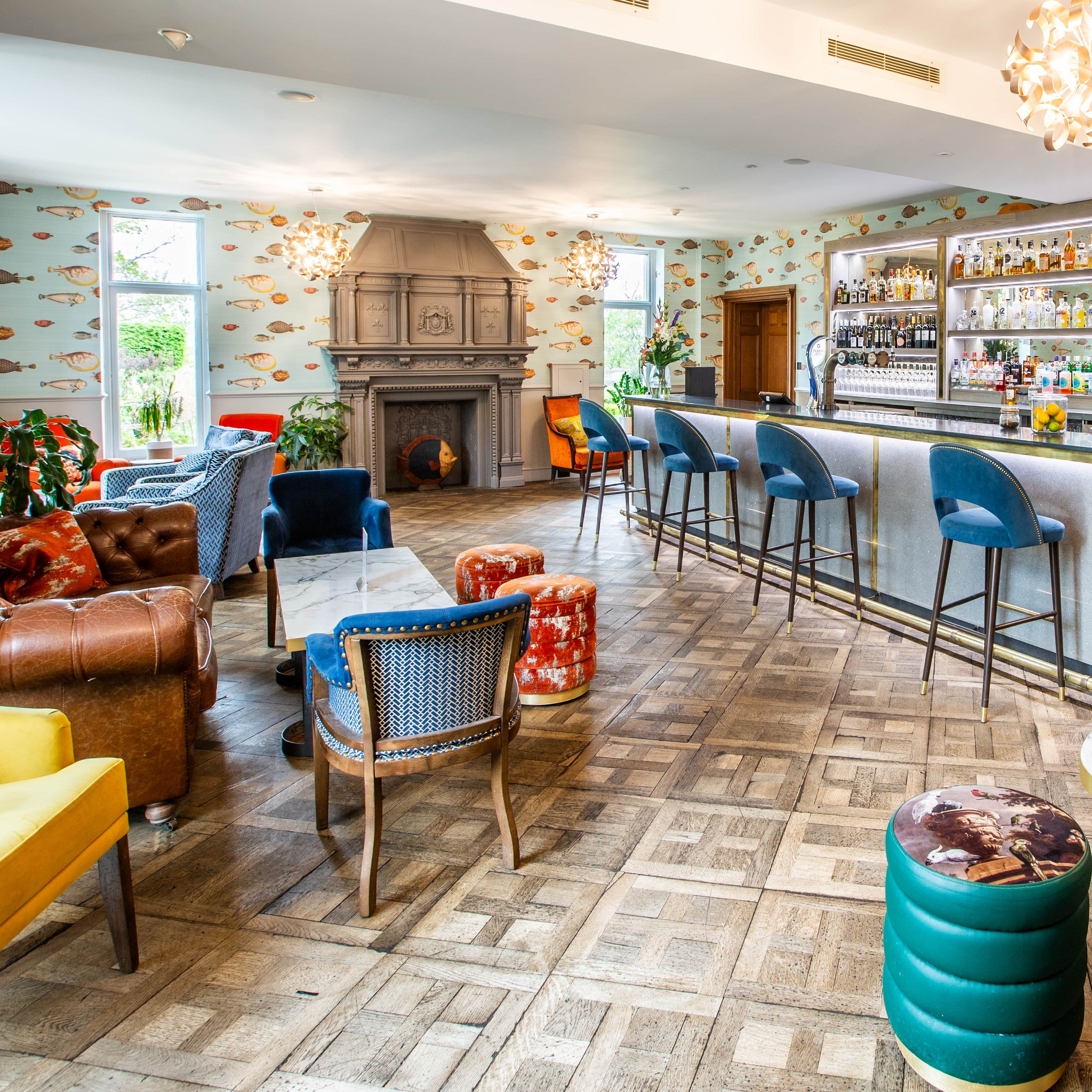 A view of the bar area and surroundings, lots of multicoloured chairs around a codffee table