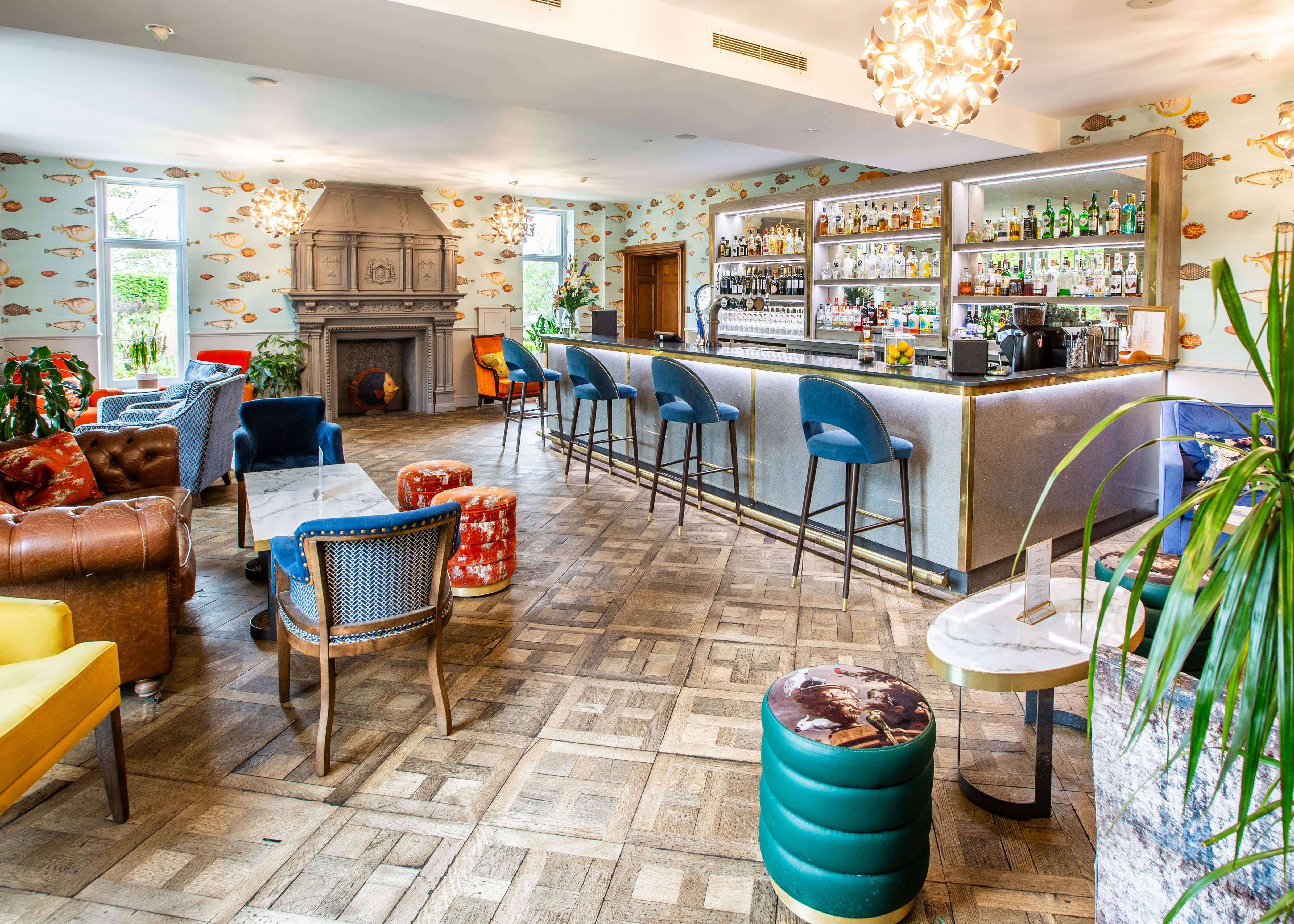 A view of the bar area and surroundings, lots of multicoloured chairs around a codffee table