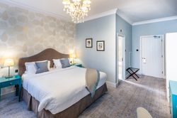 Bedroom with dressing table and large bed