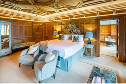 Luxury Room with two seats in front of bed