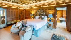 Luxury Room with two seats in front of bed