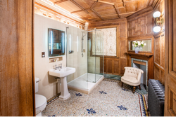 Bathroom with tiled floor and panelled wood walls
