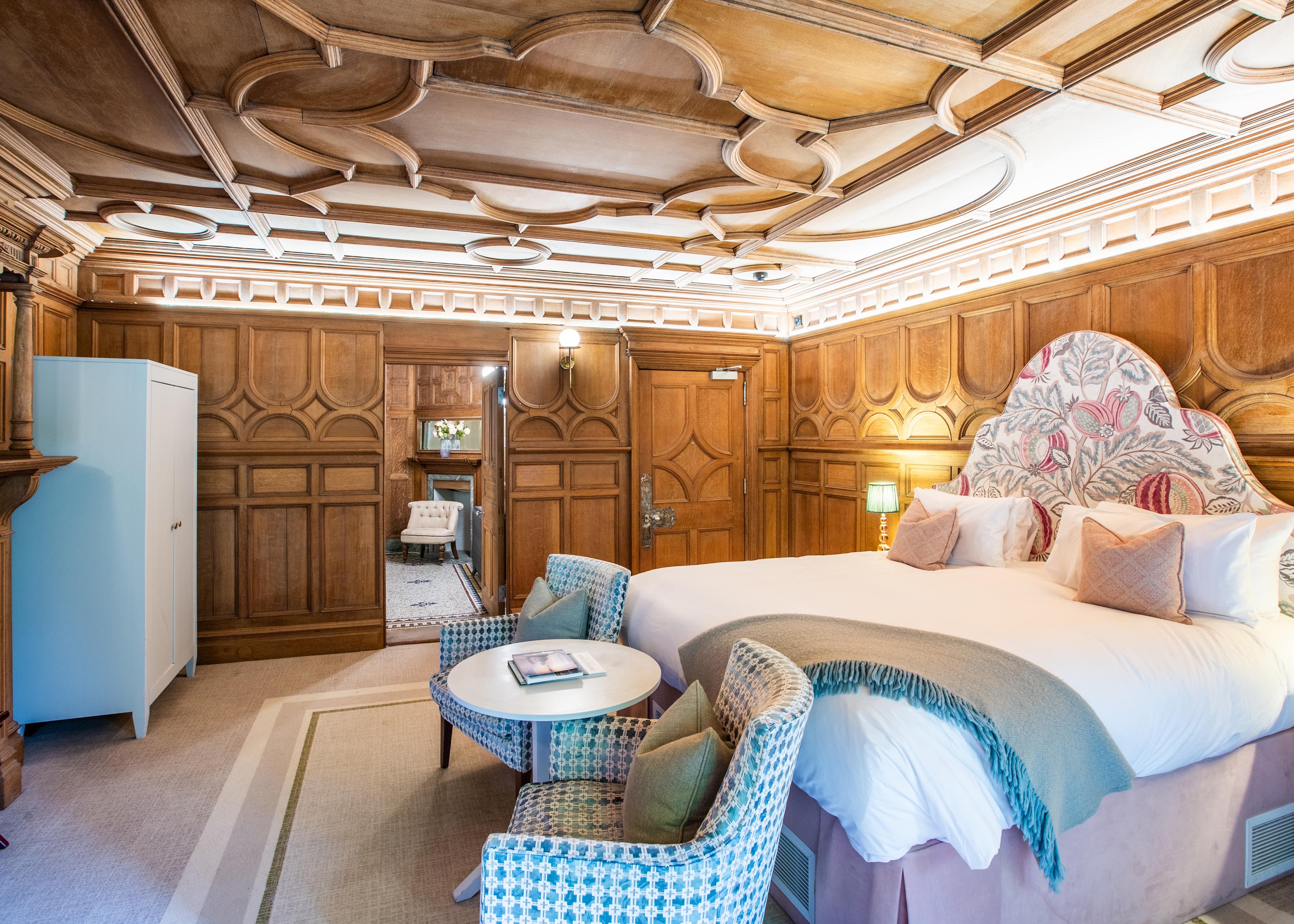 Bedroom with wooden panelled walls
