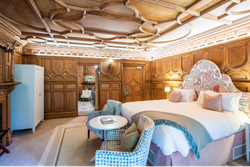 Bedroom with wooden panelled walls