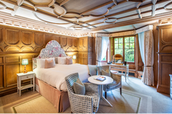Bedroom with wooden panelled walls