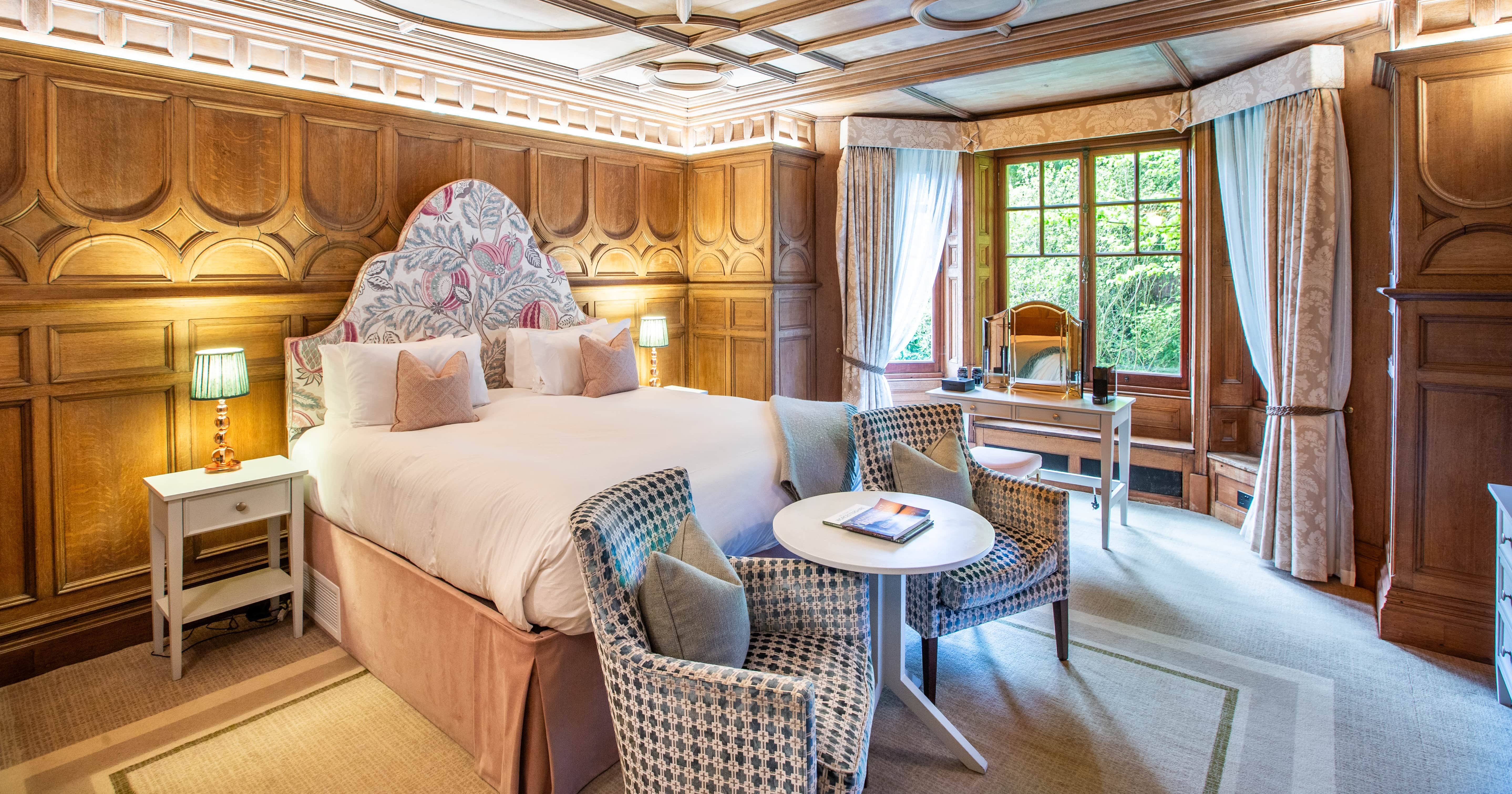 Bedroom with wooden panelled walls