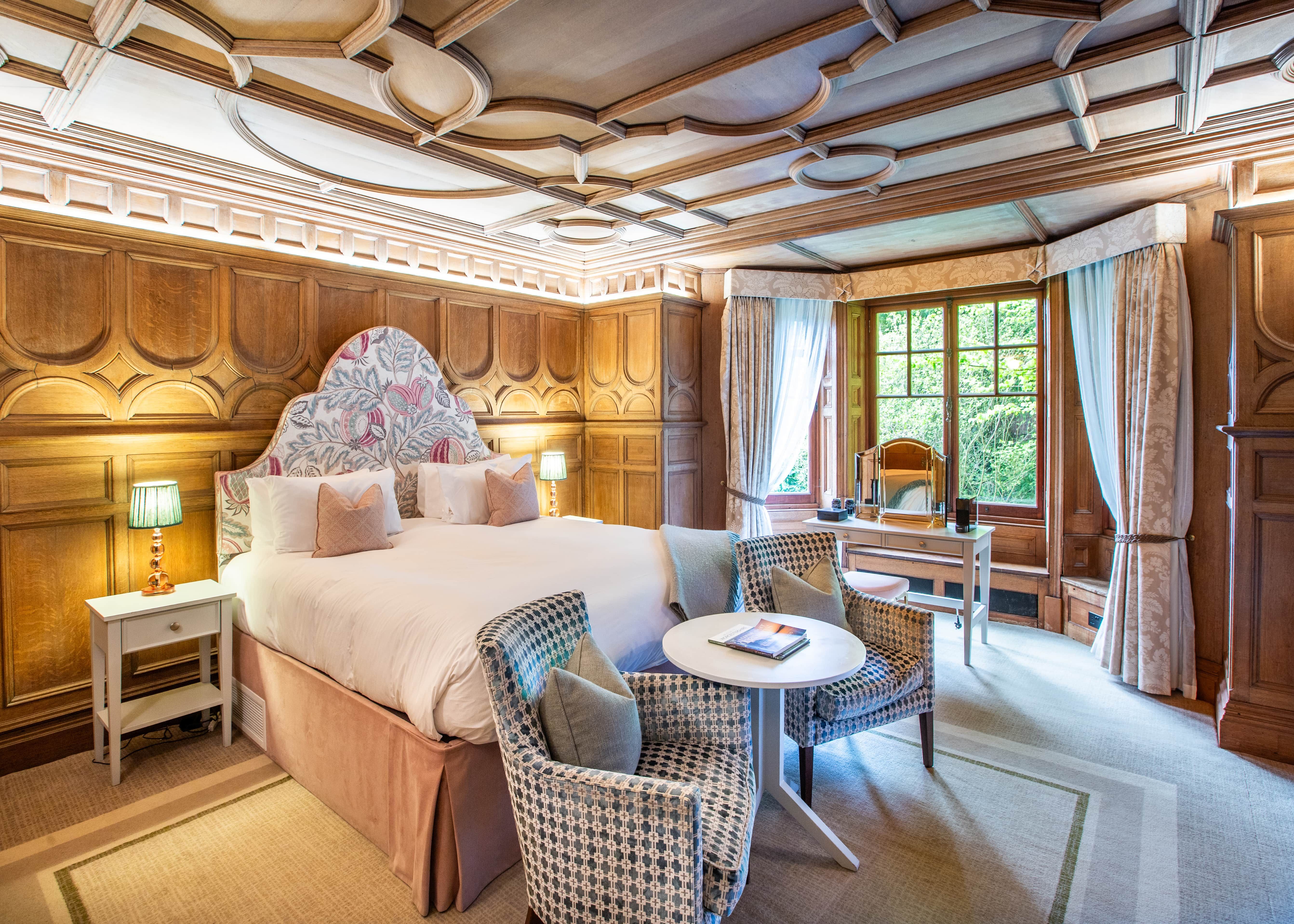 Bedroom with wooden panelled walls