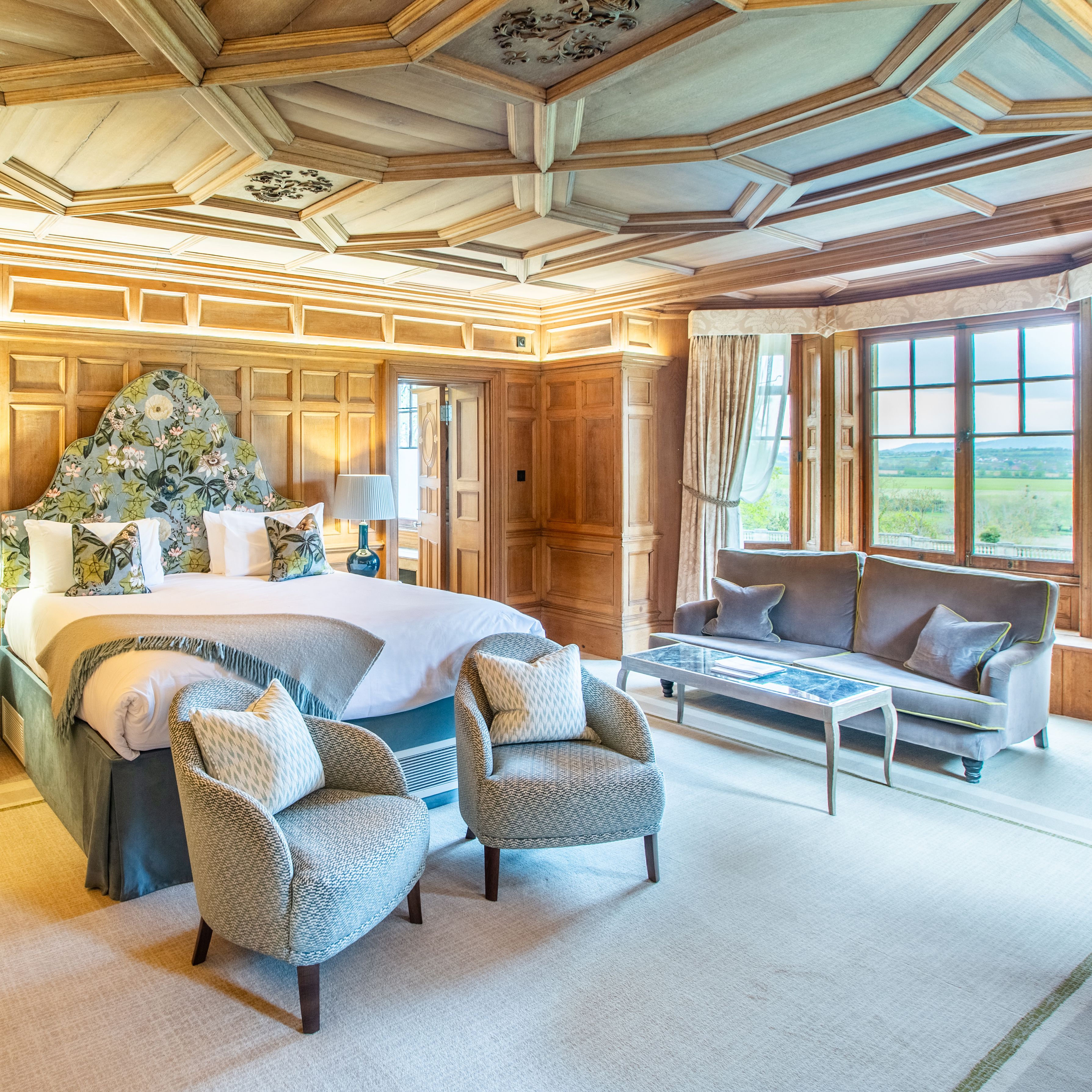 Spacious Bedroom with large window and sofas