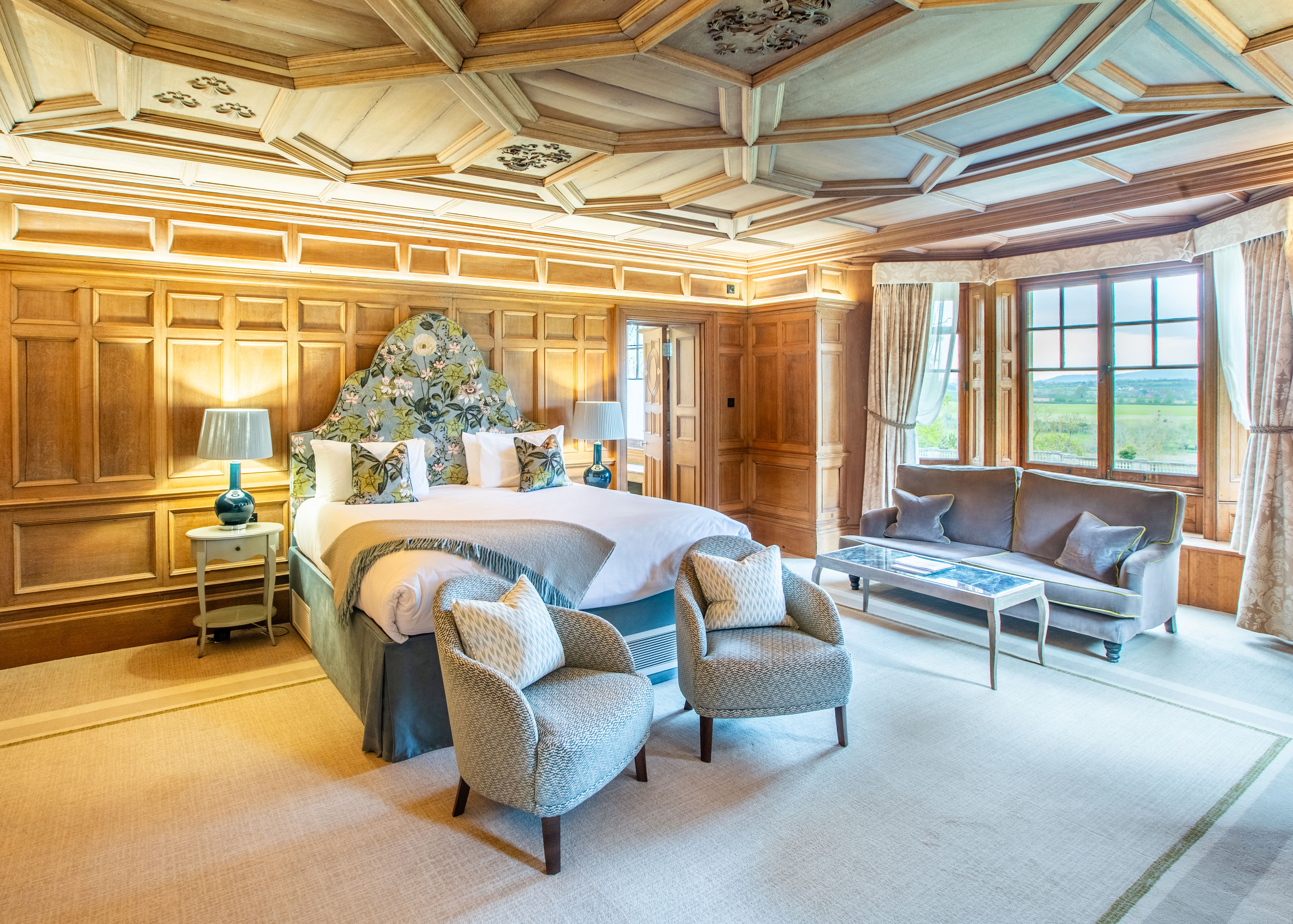 Spacious Bedroom with large window and sofas